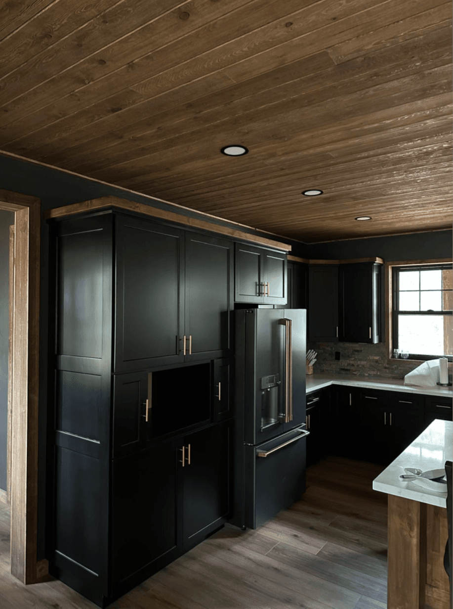 Dark cabinet kitchen with wood-plank ceiling